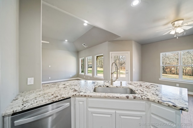 kitchen featuring stainless steel dishwasher, plenty of natural light, visible vents, and a sink