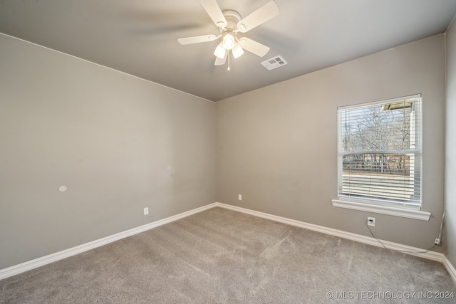 unfurnished room featuring visible vents, baseboards, ceiling fan, and carpet flooring