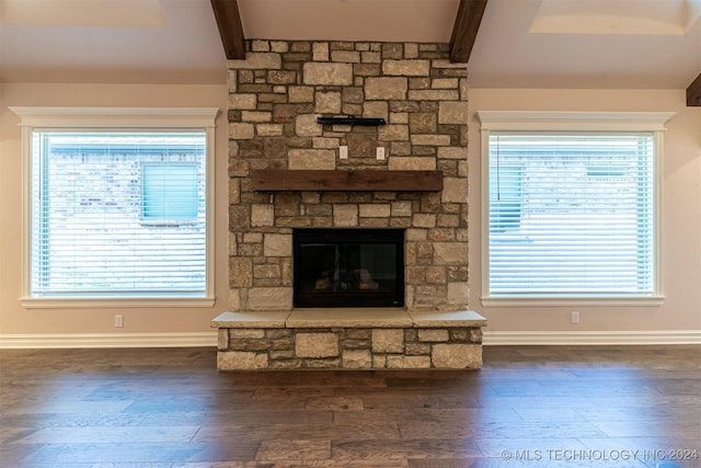 unfurnished living room featuring a fireplace, plenty of natural light, and dark hardwood / wood-style floors