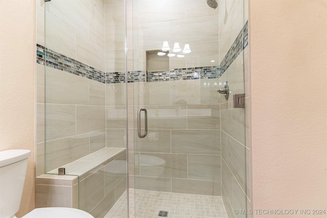 bathroom with an enclosed shower and toilet