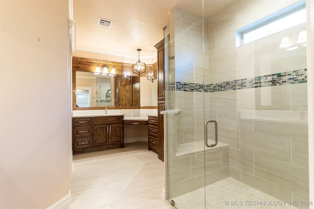 bathroom with vanity, an enclosed shower, and tile patterned flooring