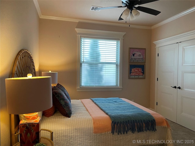 bedroom with ornamental molding, a closet, ceiling fan, and carpet