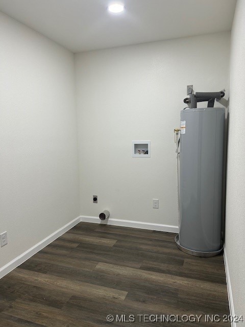 washroom featuring washer hookup, dark hardwood / wood-style floors, and water heater