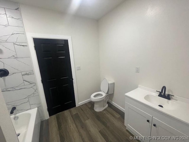 full bathroom with hardwood / wood-style floors, vanity, toilet, and  shower combination