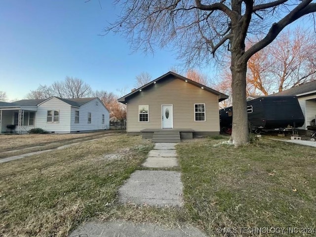 ranch-style house with a front lawn