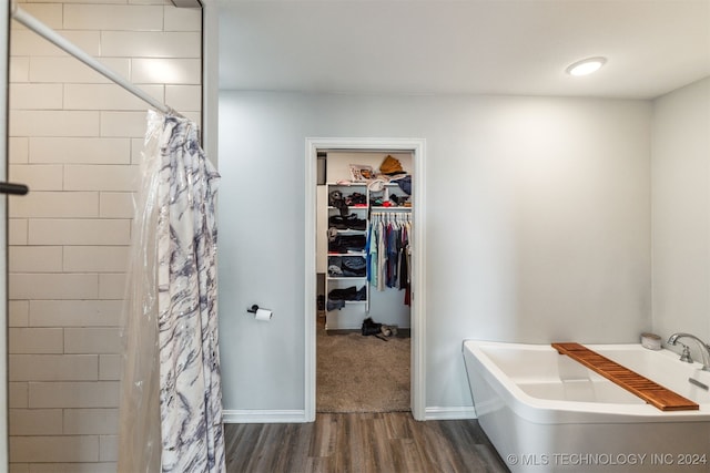 bathroom featuring hardwood / wood-style floors and a shower with shower curtain