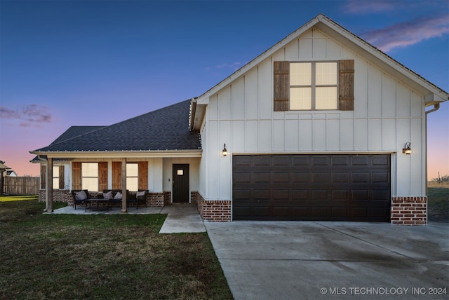 view of front of home with a yard and a garage