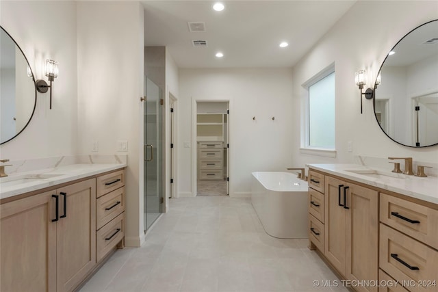 bathroom featuring tile patterned flooring, vanity, and independent shower and bath