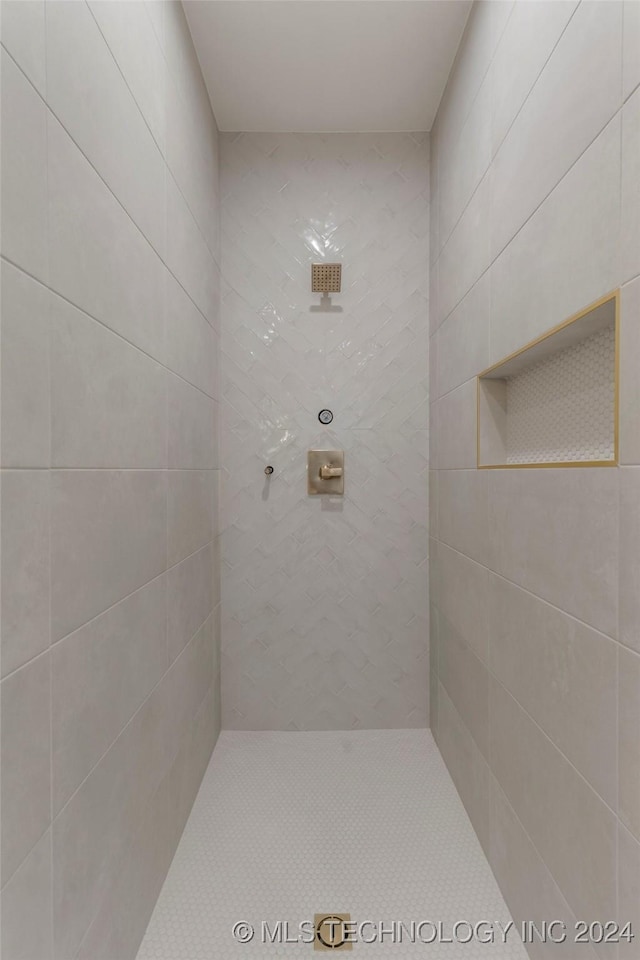 bathroom with a tile shower