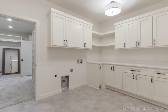 laundry area with cabinets, hookup for a washing machine, electric dryer hookup, and light tile patterned flooring