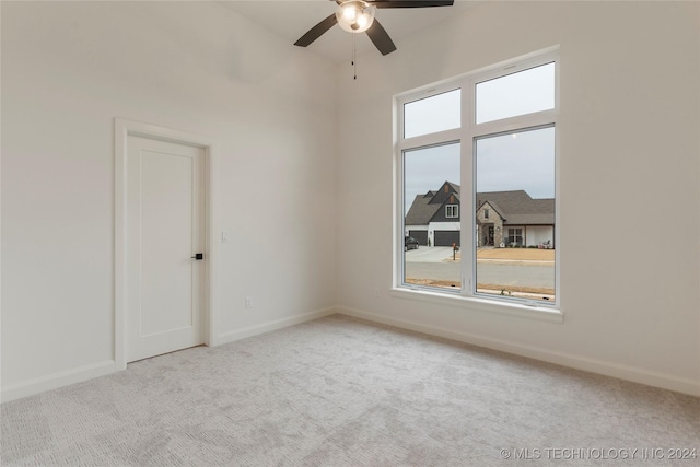 carpeted empty room featuring ceiling fan