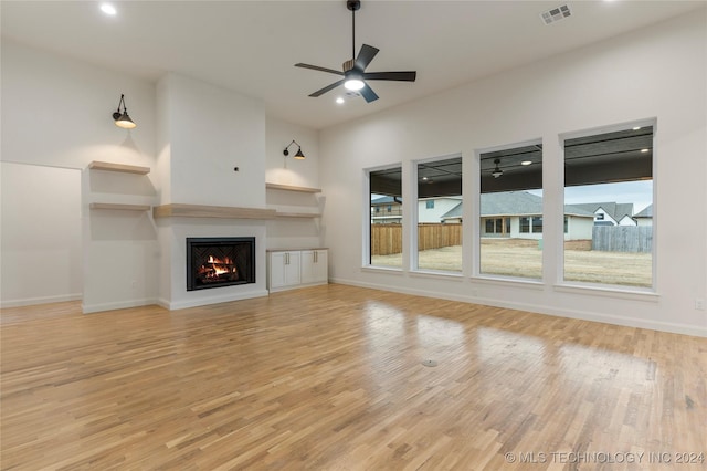 unfurnished living room featuring ceiling fan and light hardwood / wood-style floors