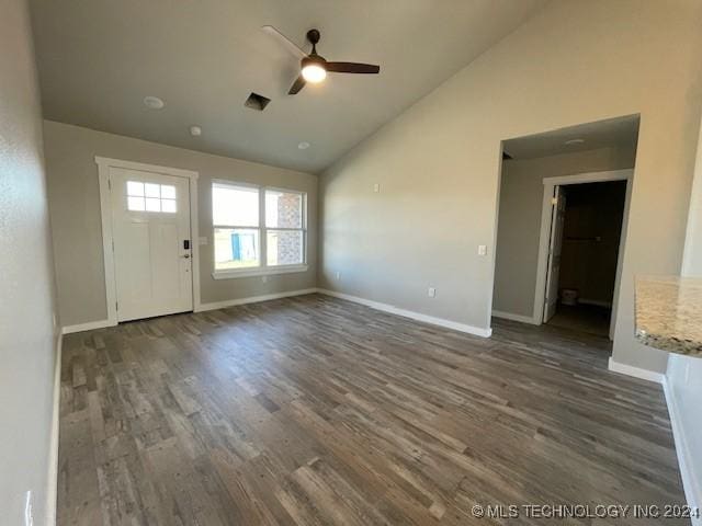 unfurnished living room with ceiling fan, dark hardwood / wood-style floors, and vaulted ceiling