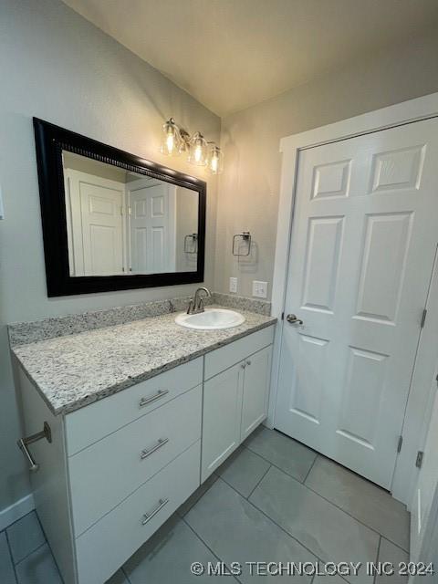 bathroom featuring tile patterned flooring and vanity