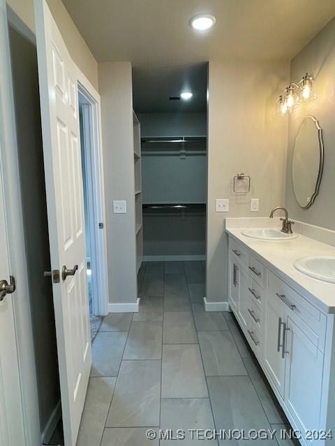 bathroom featuring tile patterned flooring and vanity