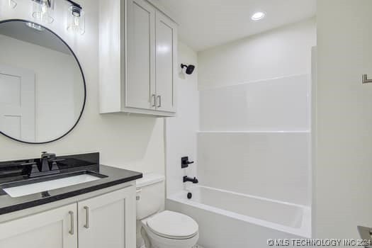 full bathroom featuring toilet, vanity, and tub / shower combination