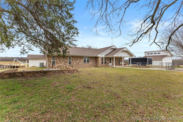 ranch-style home featuring cooling unit, a front yard, and a carport