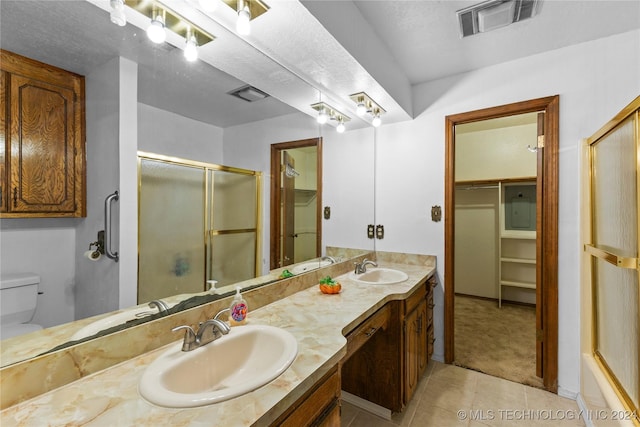 bathroom featuring tile patterned floors, vanity, and toilet