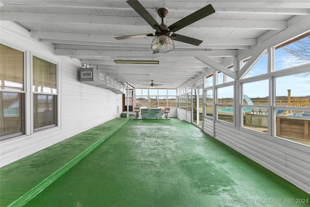 unfurnished sunroom featuring beamed ceiling