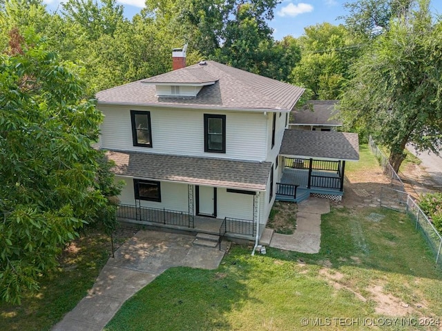 view of front of property with a porch and a front lawn