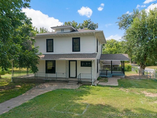 view of front of property with covered porch and a front yard