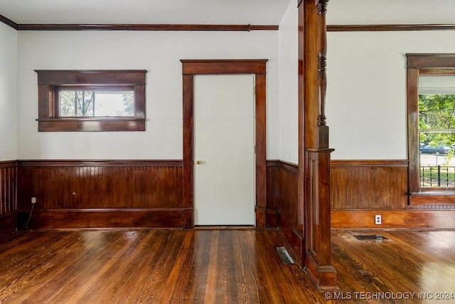 interior space featuring dark hardwood / wood-style flooring and crown molding