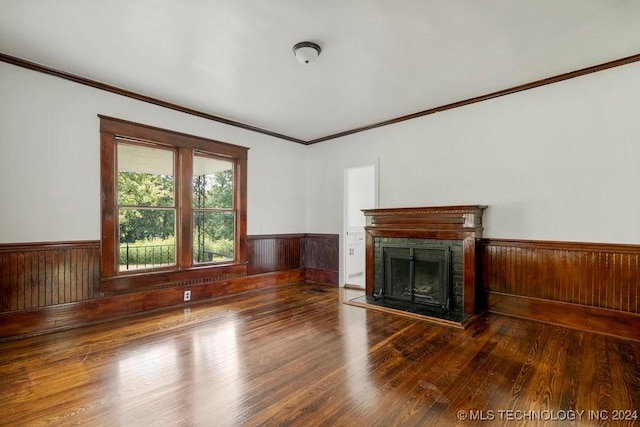 unfurnished living room with hardwood / wood-style floors and ornamental molding