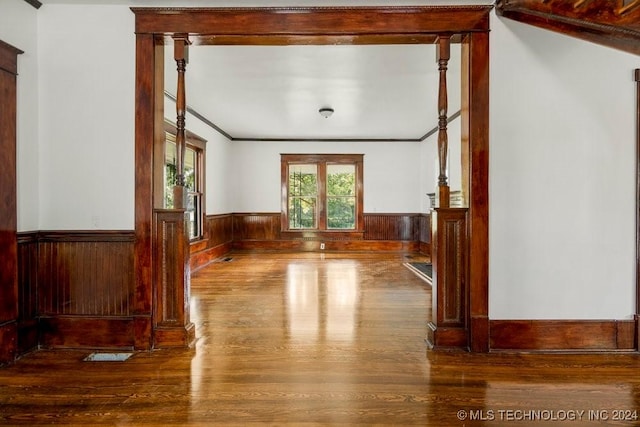 spare room featuring hardwood / wood-style flooring and ornamental molding