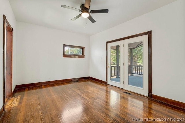 spare room with ceiling fan and dark wood-type flooring