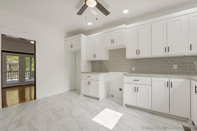 kitchen with french doors, ceiling fan, light stone countertops, tasteful backsplash, and white cabinetry