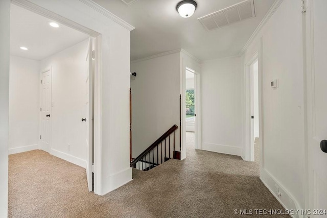 hall with light carpet and ornamental molding