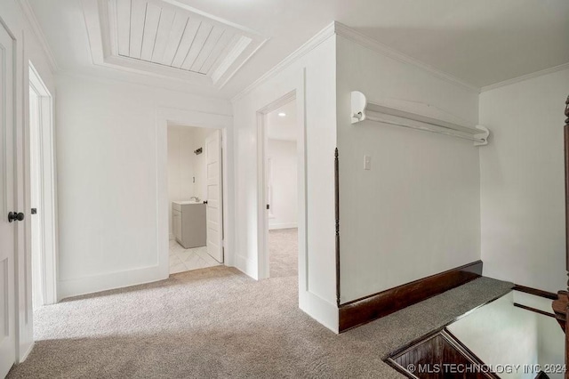 hallway featuring ornamental molding and light carpet