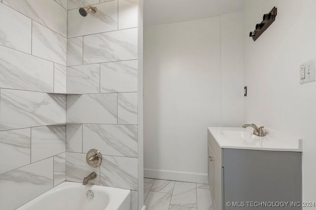 bathroom featuring vanity and tiled shower / bath