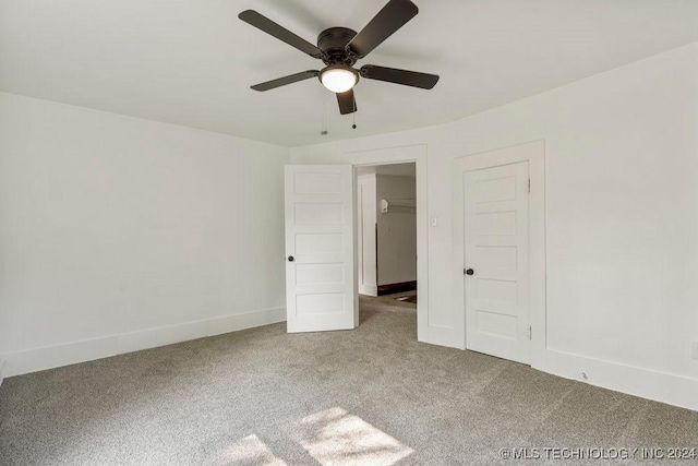 unfurnished bedroom featuring carpet, a closet, and ceiling fan