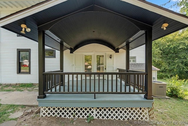 wooden deck with a porch and cooling unit