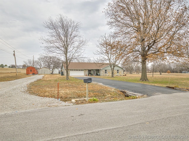 view of front of property with a front yard and a garage