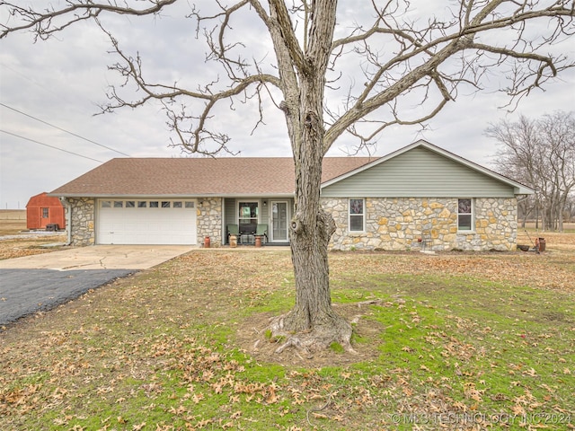 ranch-style home featuring a garage and a front lawn