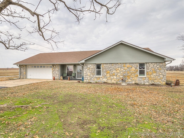 ranch-style home with a front yard and a garage