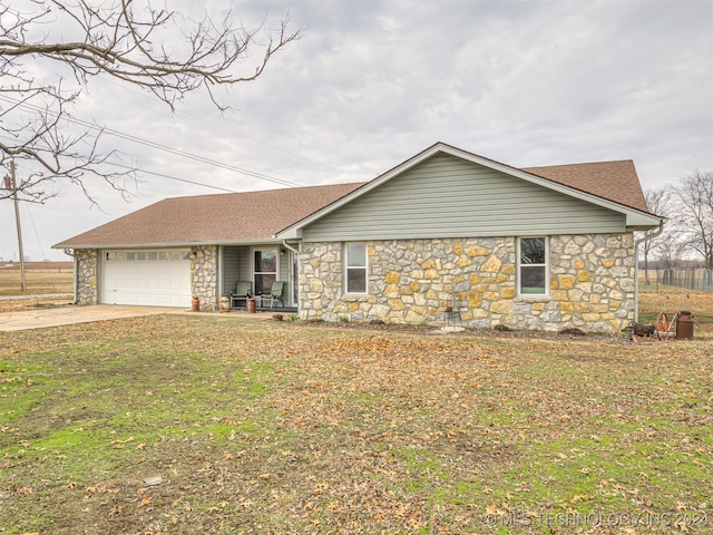 ranch-style home with a garage and a front yard