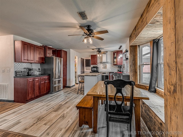 dining space with ceiling fan and light hardwood / wood-style floors