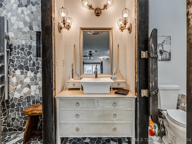 bathroom featuring ceiling fan, vanity, and toilet