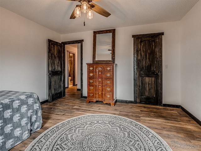 bedroom featuring ceiling fan, a textured ceiling, and hardwood / wood-style flooring