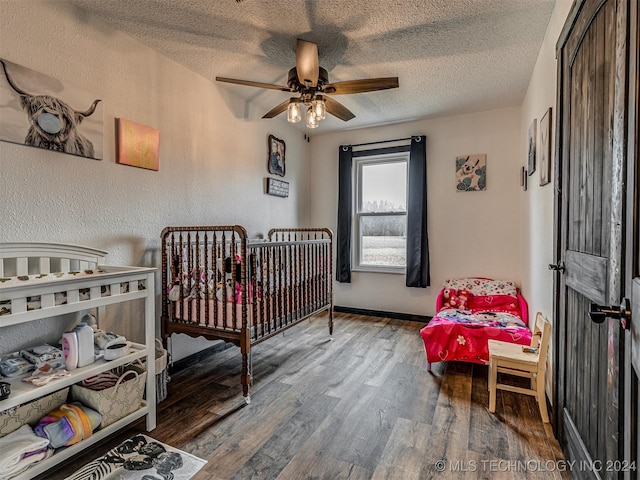 bedroom with wood-type flooring, a textured ceiling, and ceiling fan