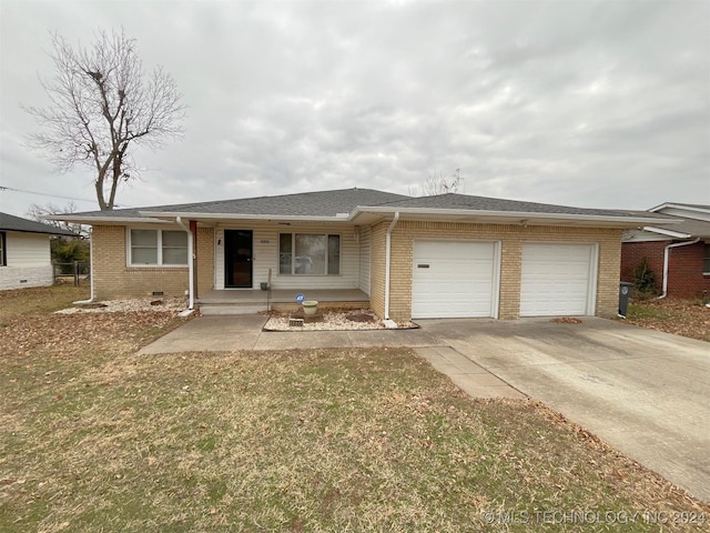 ranch-style house featuring a front yard and a garage