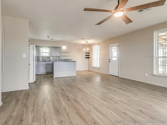 unfurnished living room with hardwood / wood-style floors and ceiling fan