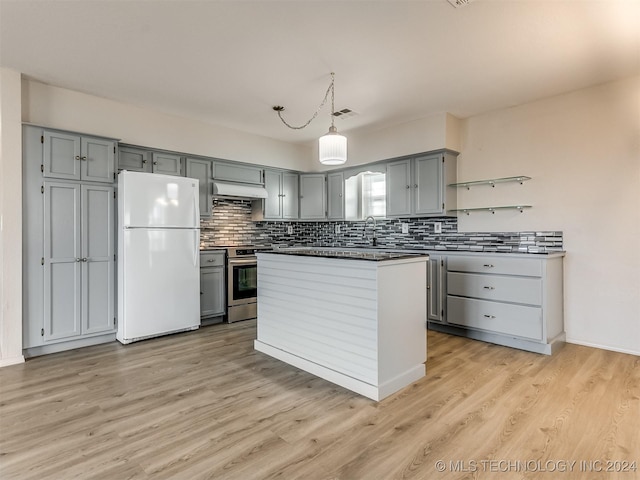 kitchen featuring gray cabinetry, white fridge, light hardwood / wood-style floors, and stainless steel stove