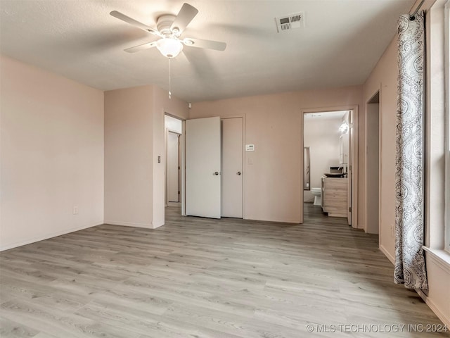 empty room with light wood-type flooring and ceiling fan