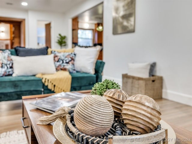 living area featuring baseboards, recessed lighting, and light wood-style floors