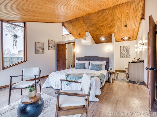 bedroom with high vaulted ceiling, wood ceiling, baseboards, and wood finished floors