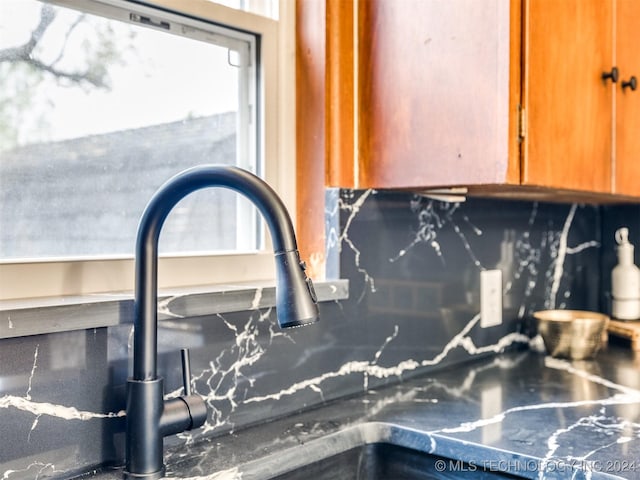 details with brown cabinetry, a sink, and decorative backsplash